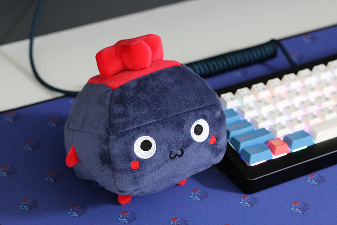 The plushie next to a keyboard.