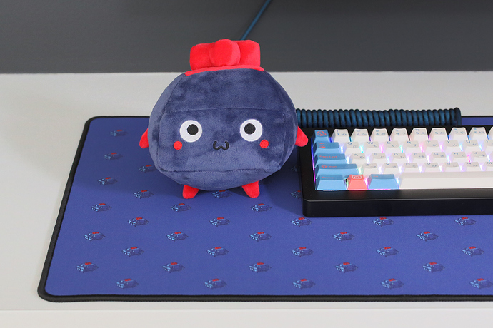 The plushie next to a keyboard.