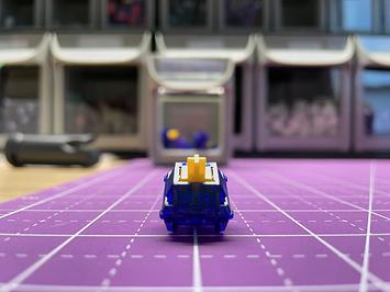 A glittery, crystalline deep blue switch with a yellow stem