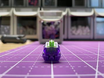 A switch with a solid purple bottom, transparent purple top, and a neon green stem